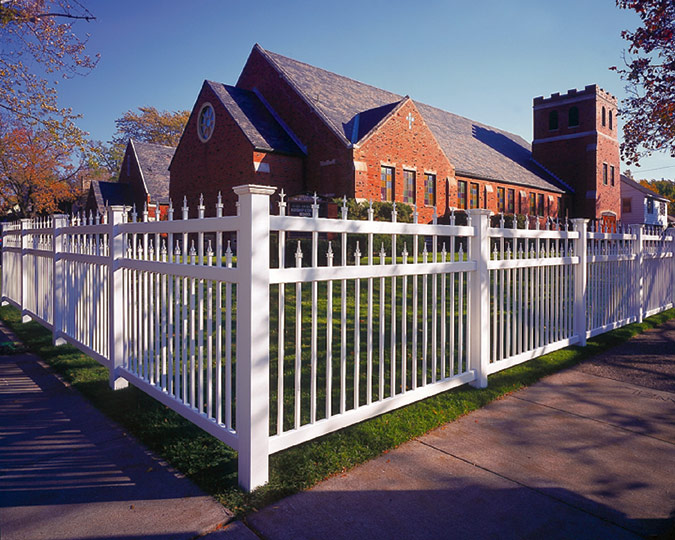 pvc picket fence with decorative elements installed around a Milwaukee church